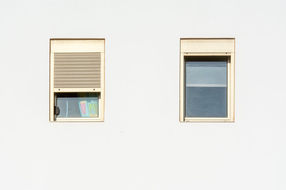 White custom window blinds installed in a bright room