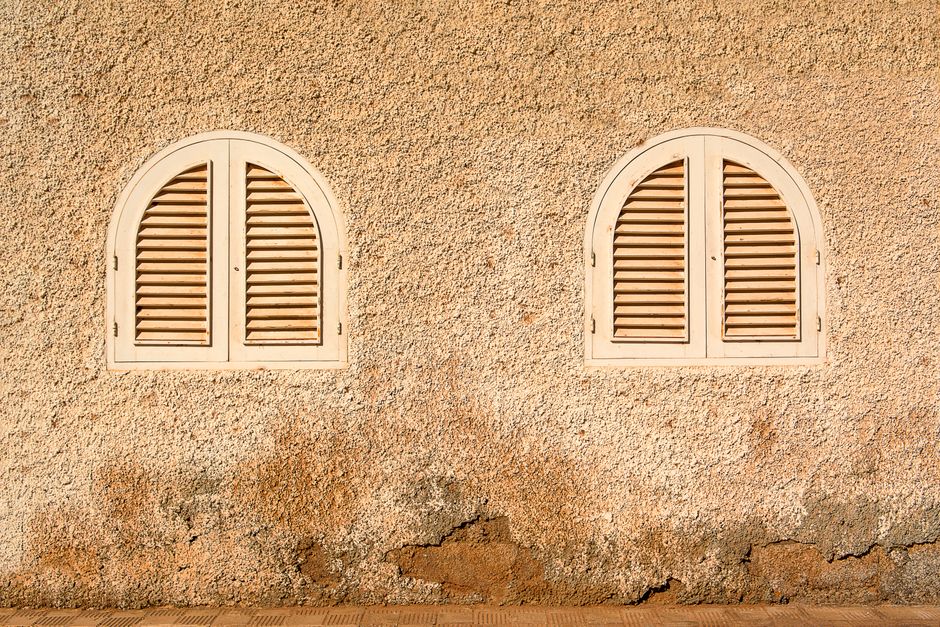 Elegant wooden plantation shutters on a large window